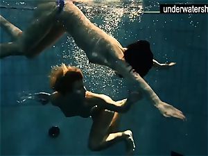 two handsome amateurs demonstrating their figures off under water